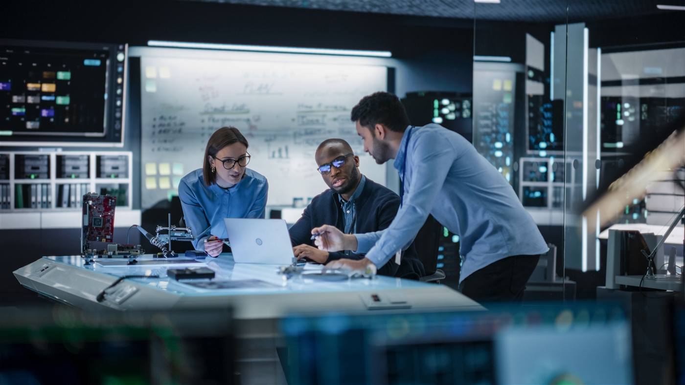 Operations team reviewing data in a low-light environment